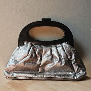 Elegant Silver Handbag with Black Handle